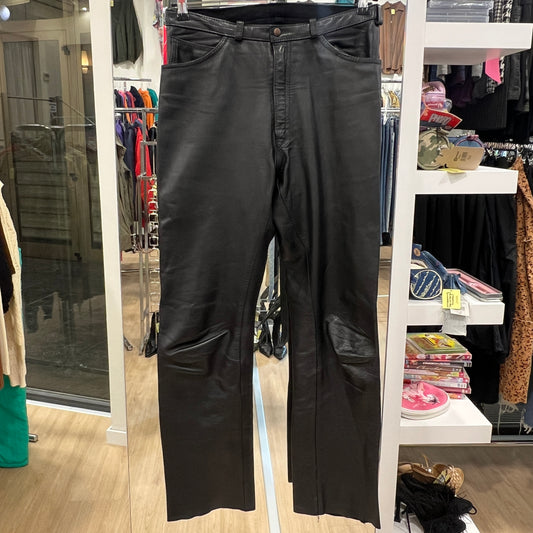 Black pants hanging on a rack in a store setting