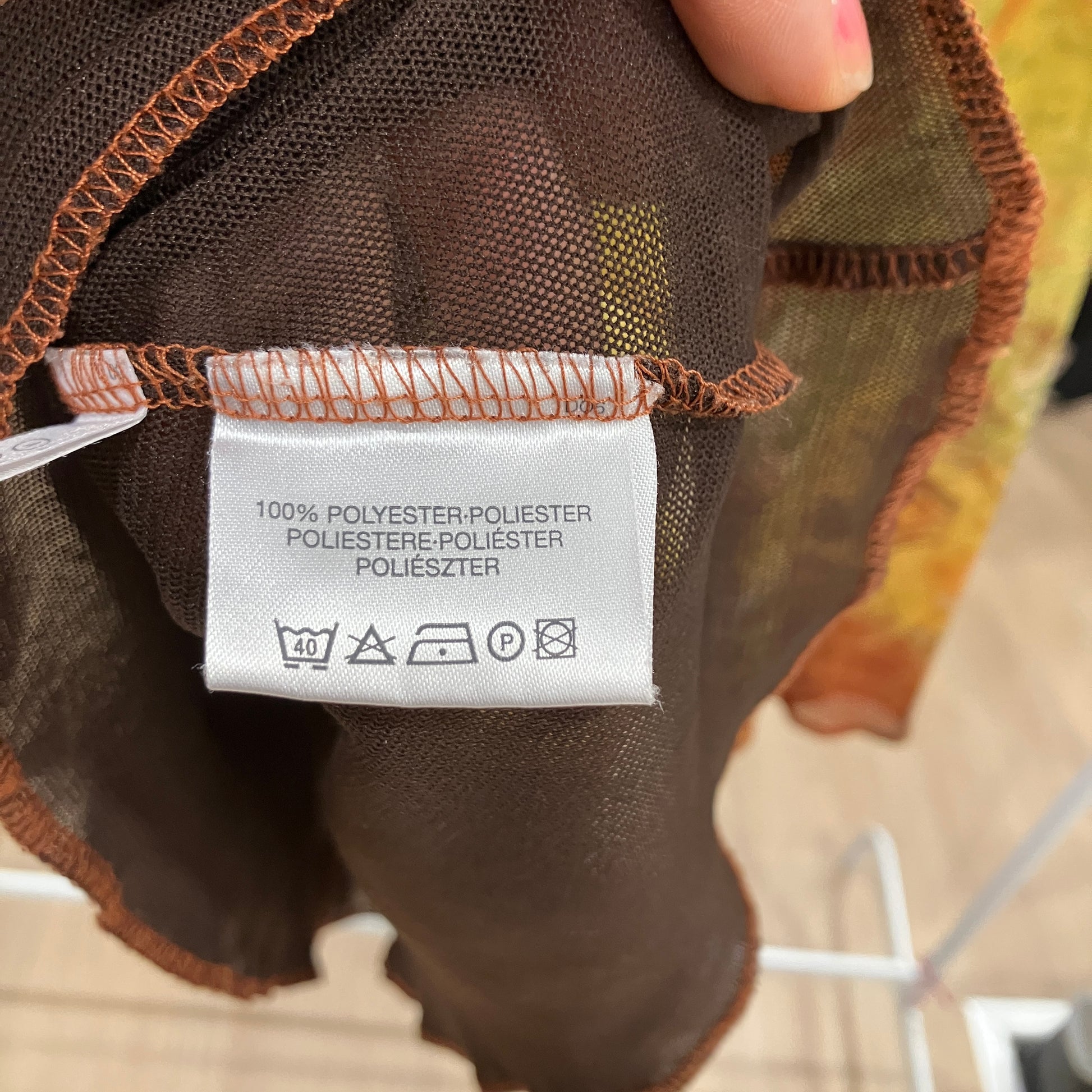 Close-up of a label on a brown hairpiece with a blurred background