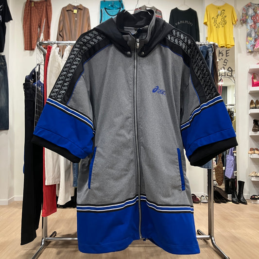Gray and blue jacket with brand logo on a clothing rack in a store