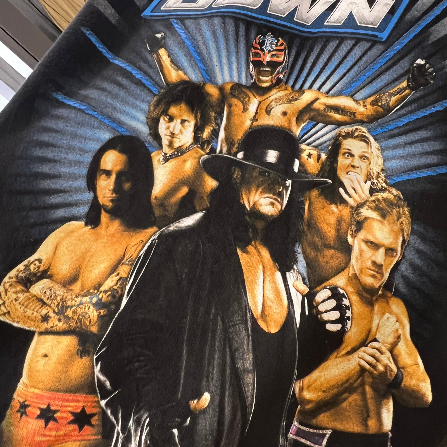 Wrestling-themed graphic with characters and text on a dark background