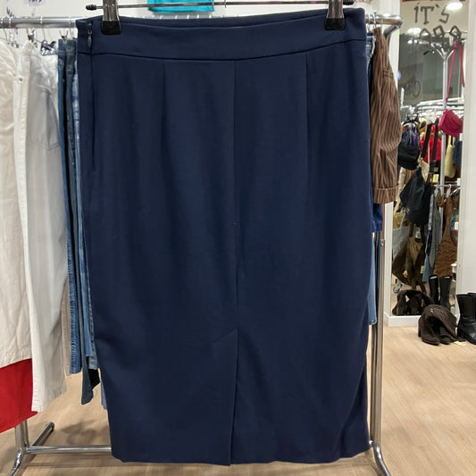 Navy blue skirt hanging on a rack in a store setting