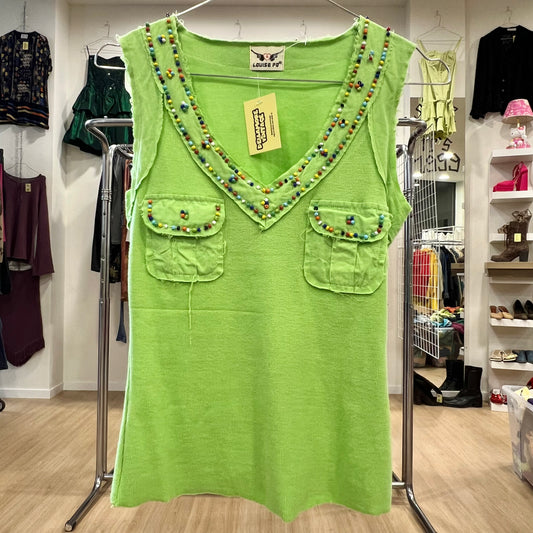 Green sleeveless top with bead embellishments on a rack in a store setting.