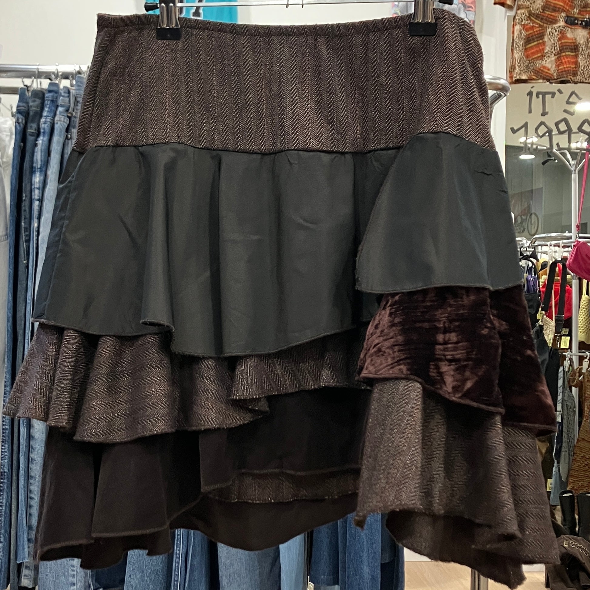 Multicolored layered skirt on a rack with jeans in the background