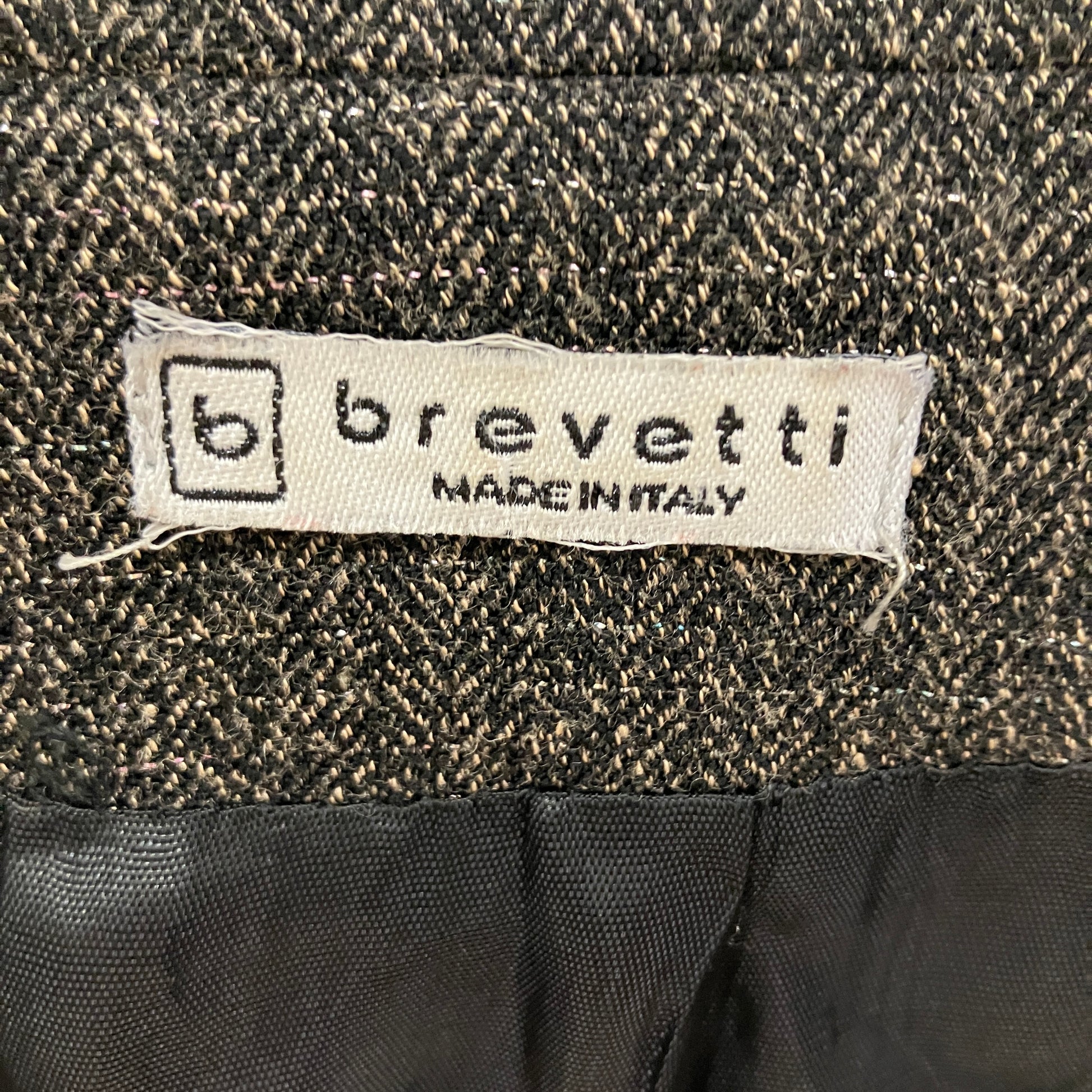 Brevetti label on a textured fabric background