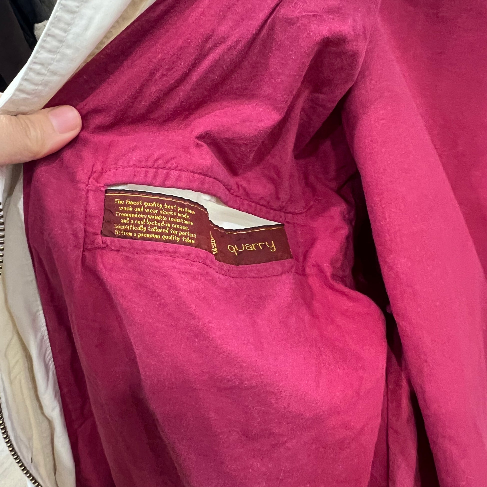 Close-up of a pink jacket with a 'quarry' brand label
