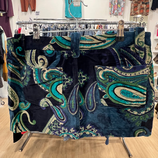 Blue and green patterned shorts on a clothing rack in a store