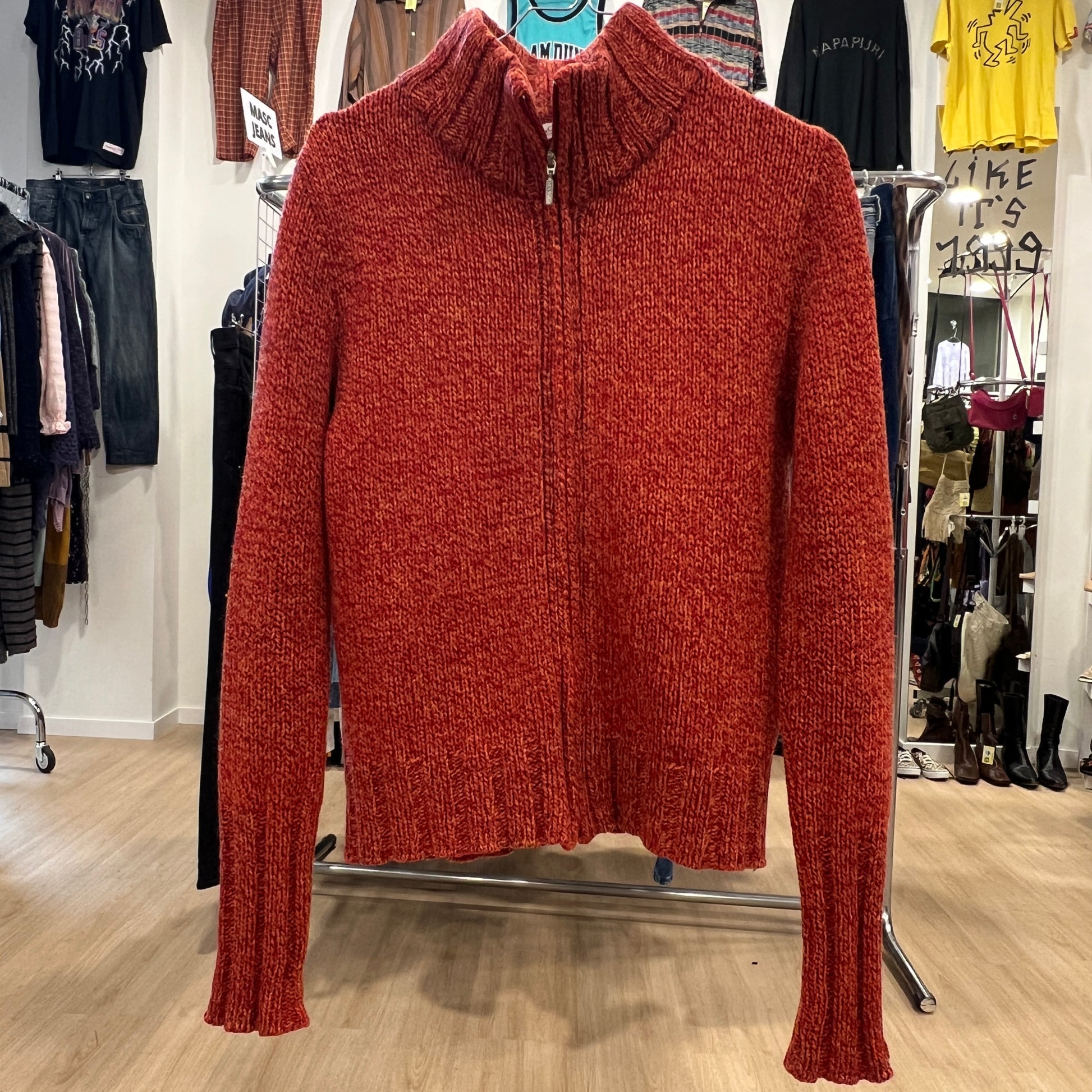 Red sweater on a rack in a clothing store