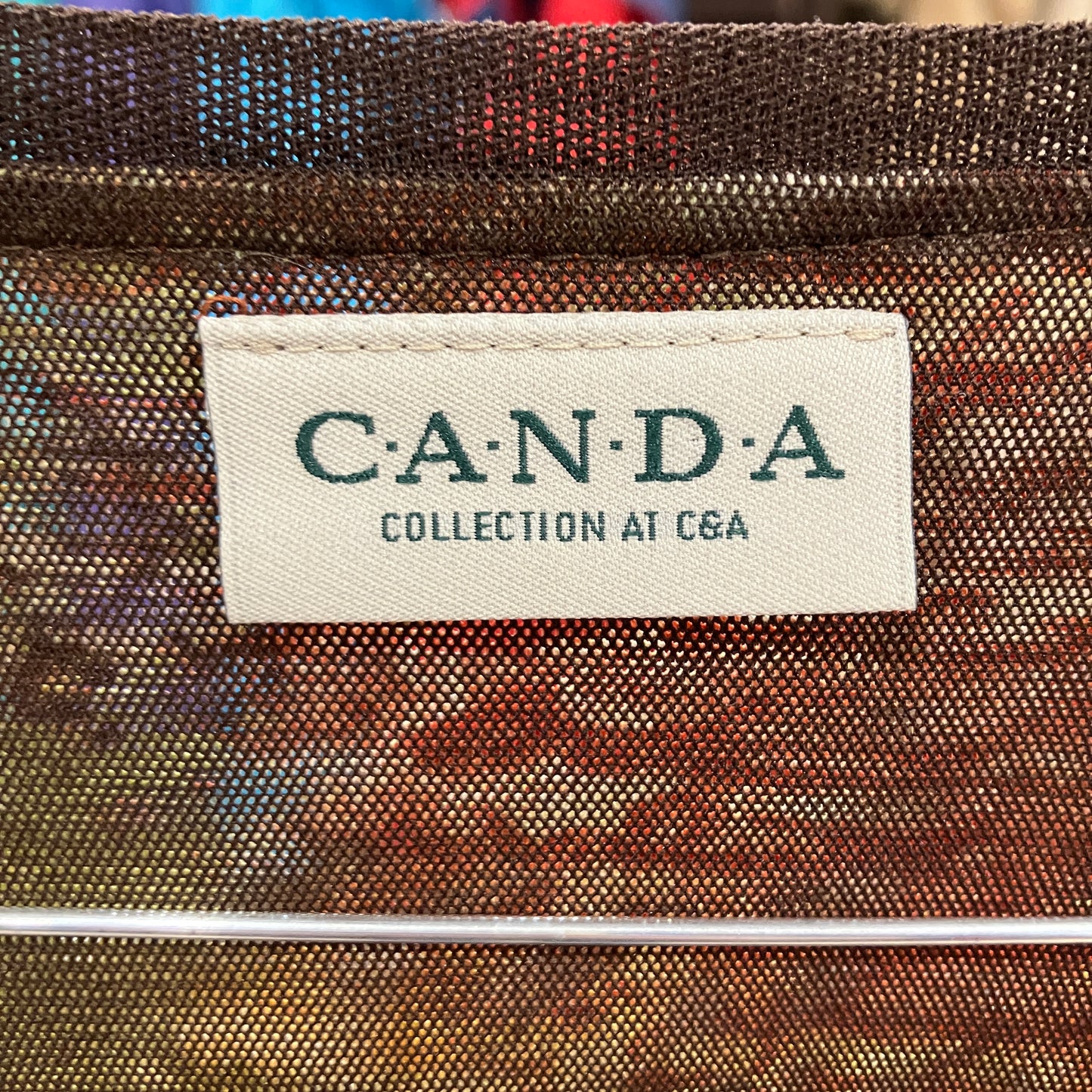 Textile product with a 'CANDA' label on a textured brown background