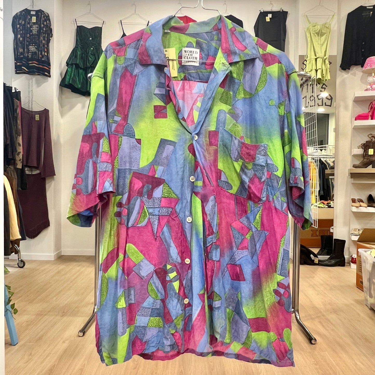 Colorful patterned shirt on a rack in a store setting