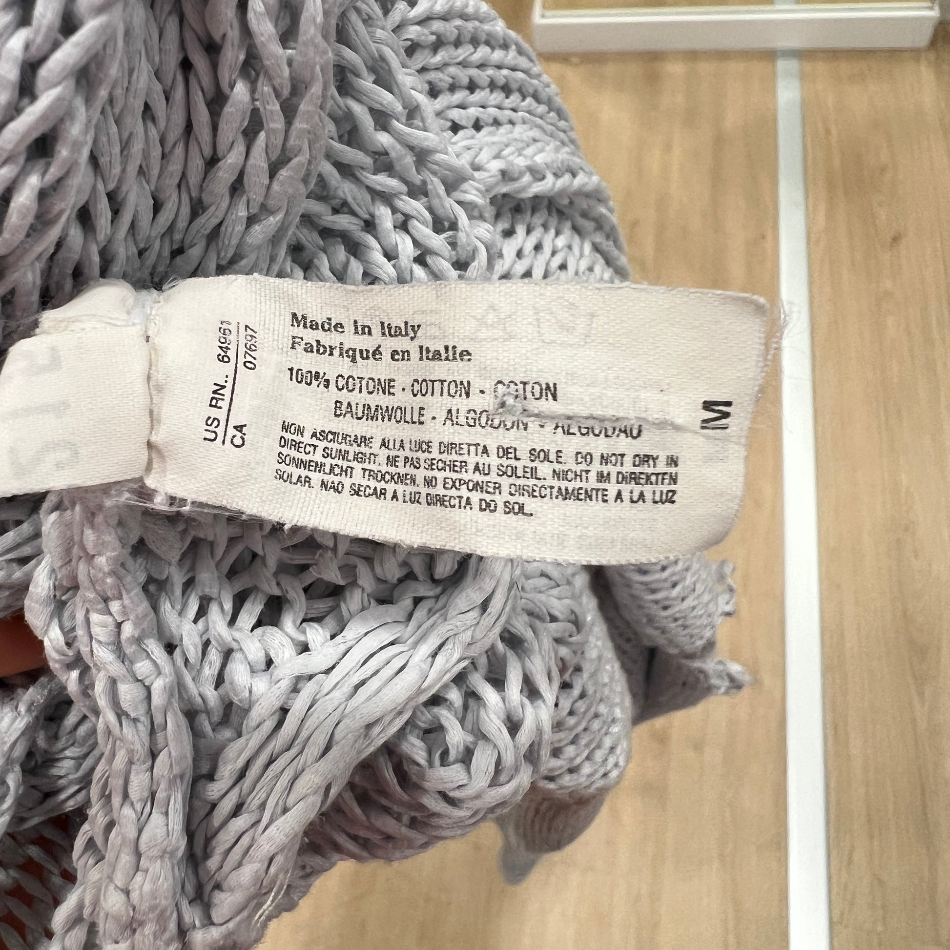 Textile product with a label on a wooden surface