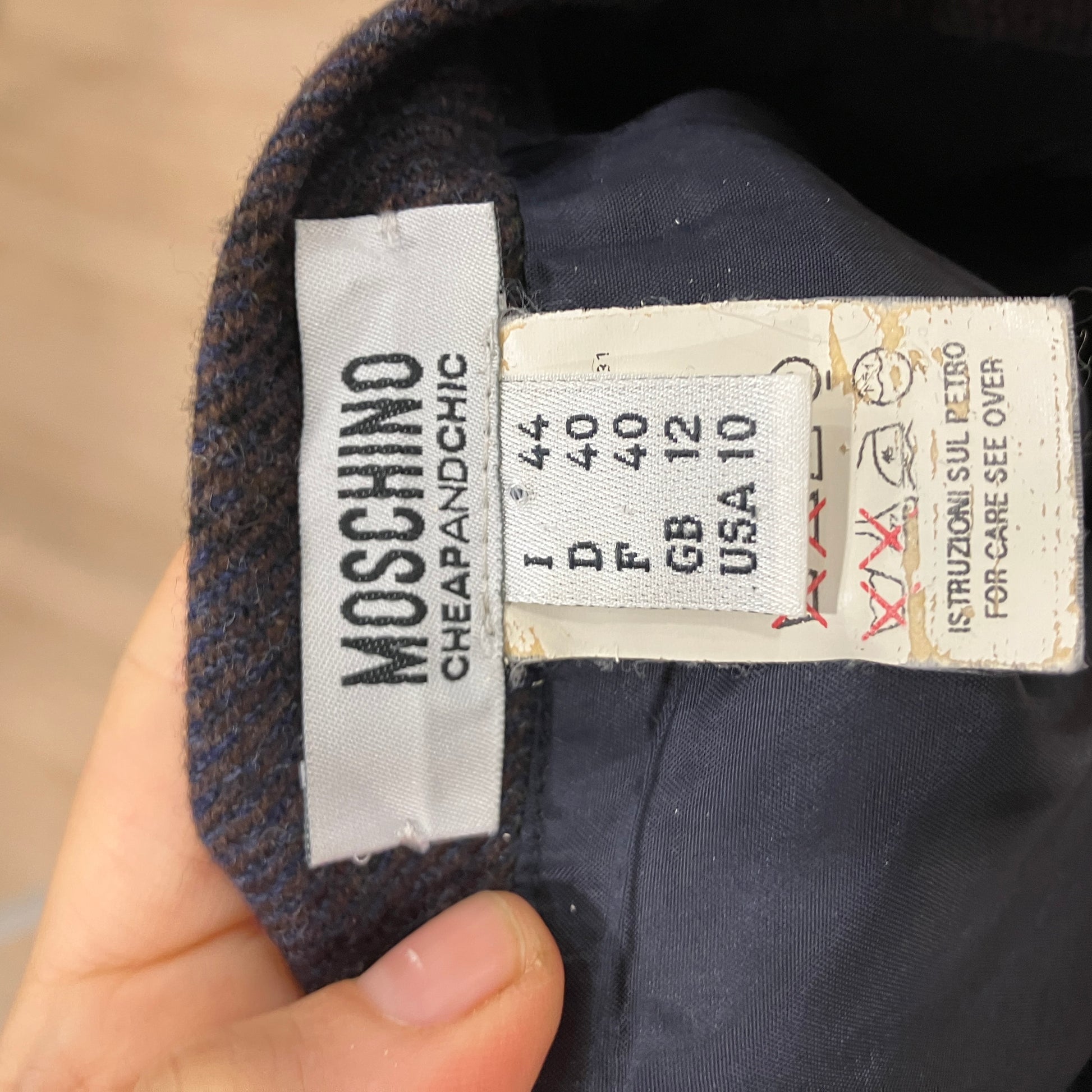 Close-up of a Moschino label on a garment with size information