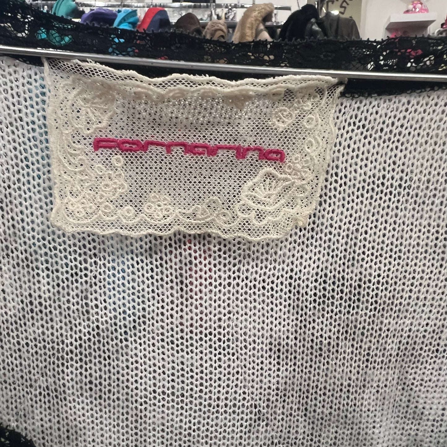 Close-up of a lace detail with 'Ferragamo' branding on a textured surface