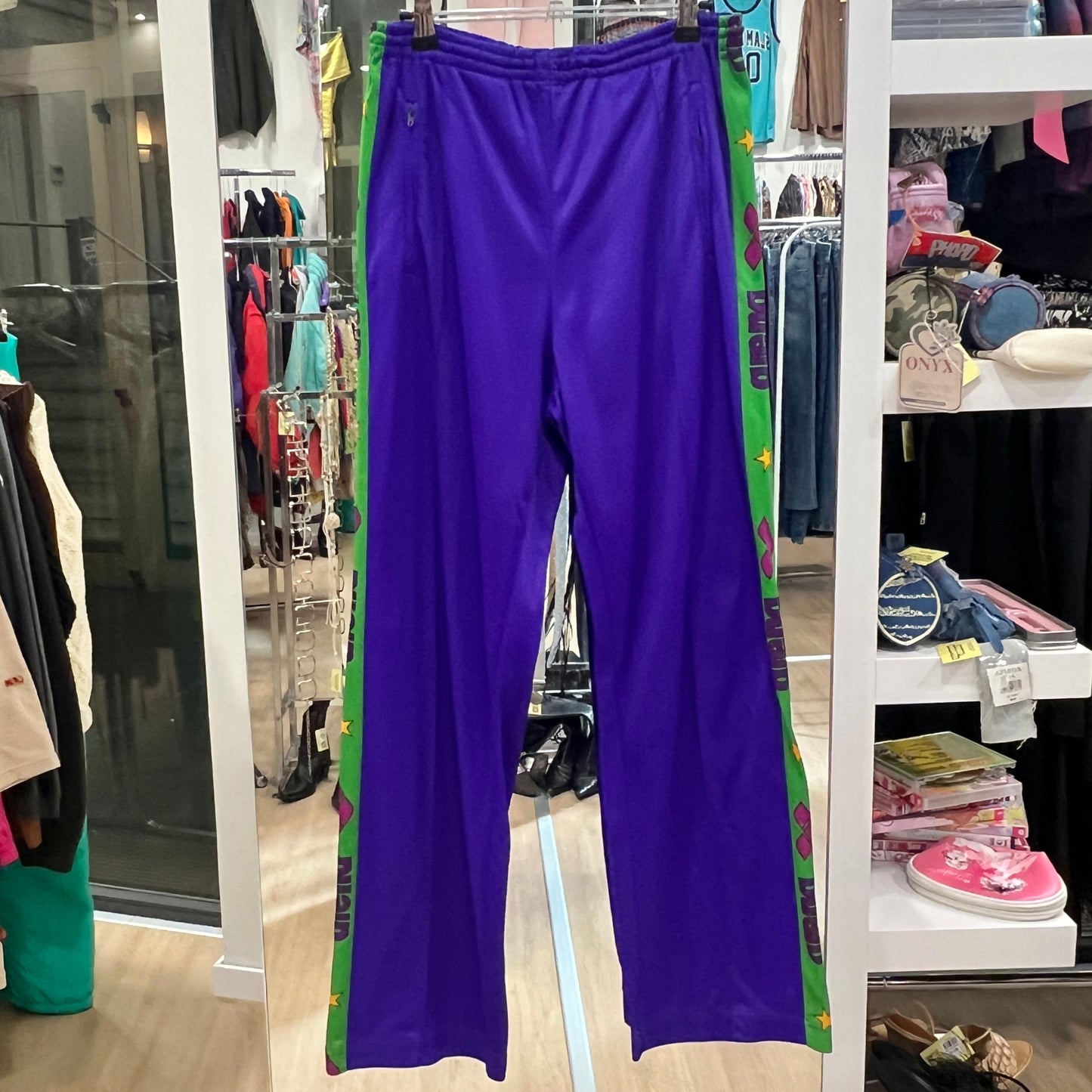 Purple pants hanging on a rack in a store setting