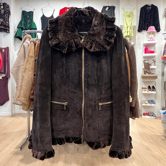 Brown suede jacket with fur collar in a clothing store