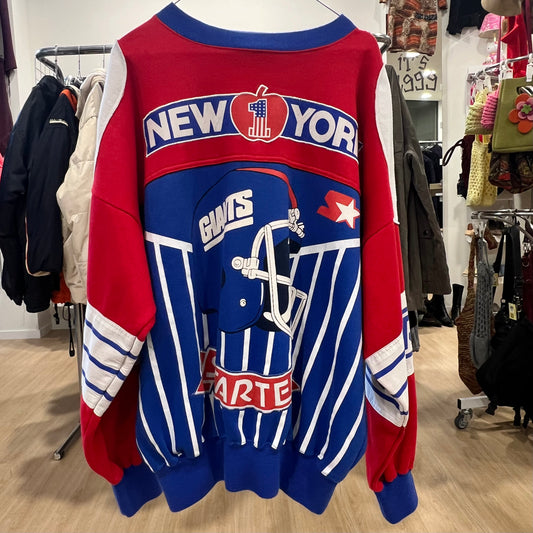 Colorful sports-themed sweatshirt with graphics and text on a rack in a store