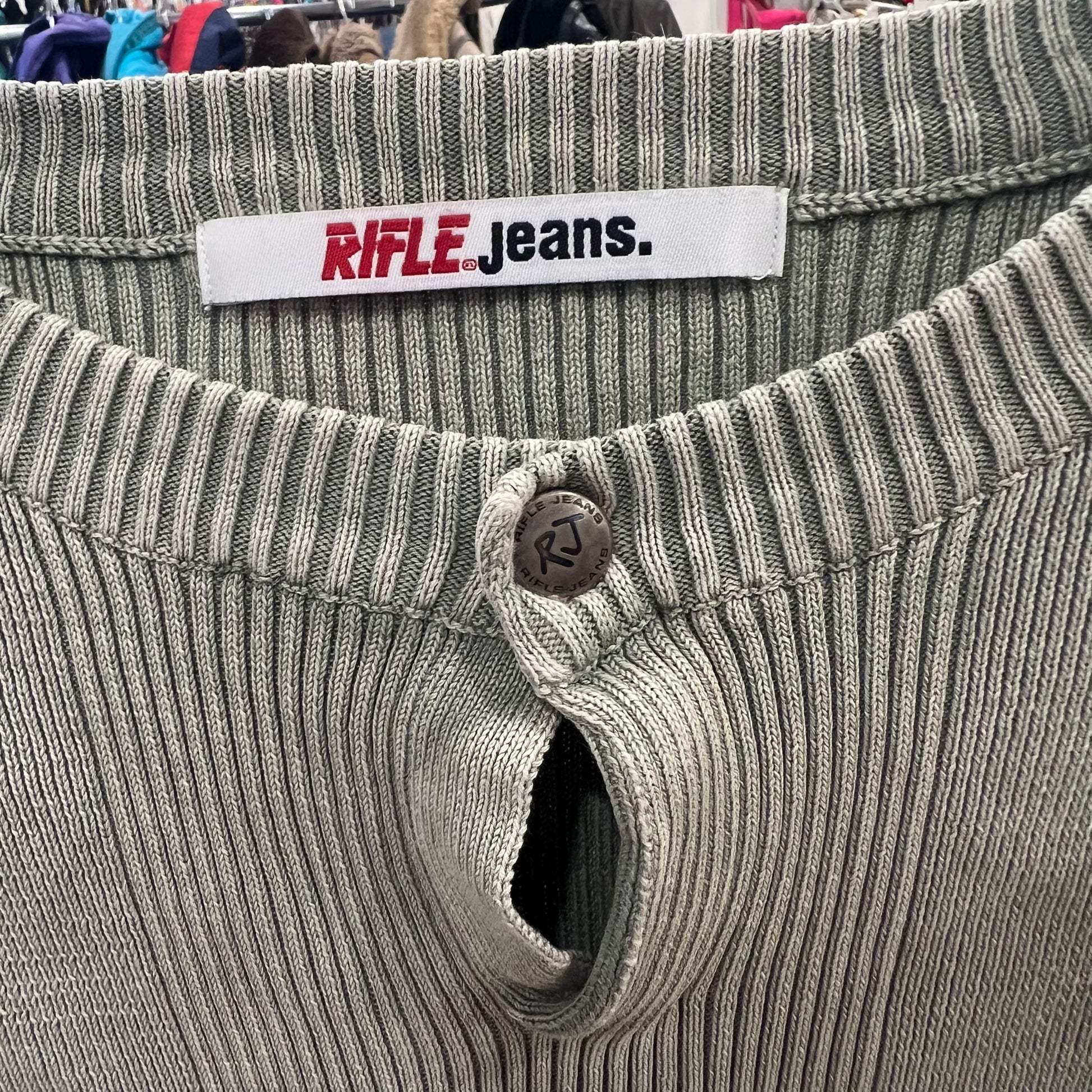 Close-up of a ribbed waistband with a 'Rifle Jeans' label on a garment