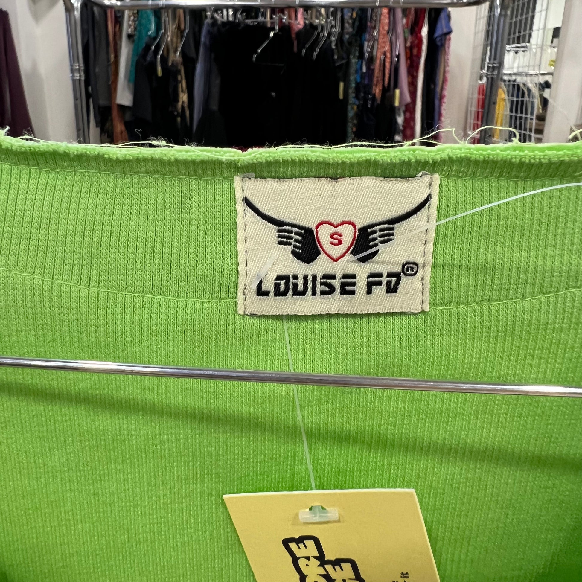 Green bag with a visible brand label in an indoor setting