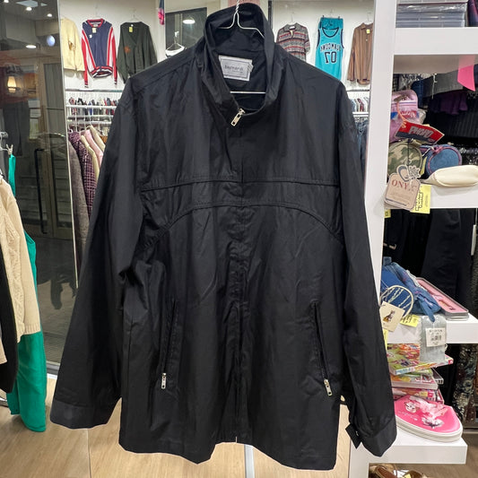 Black jacket hanging in a store with various items in the background