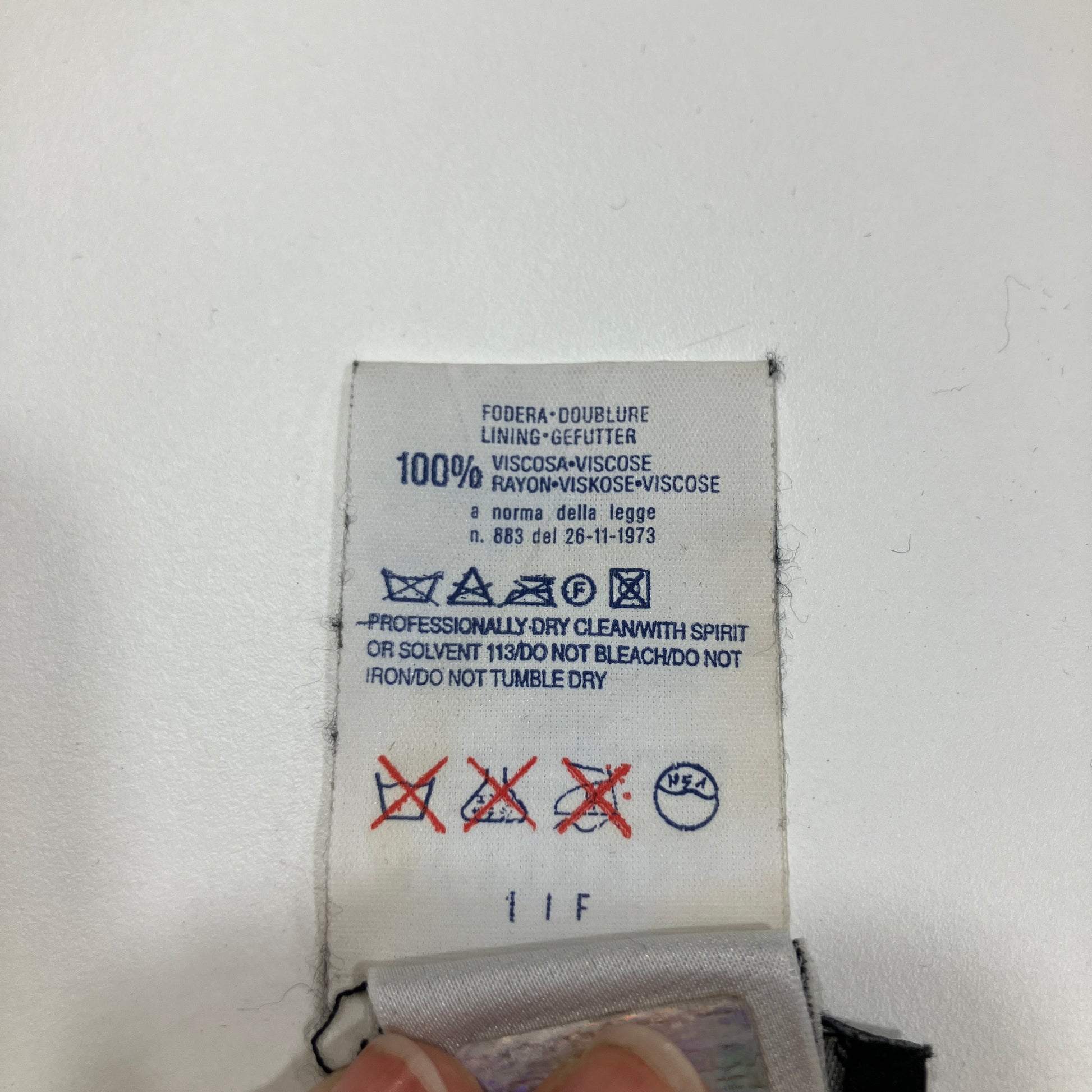 Clothing label with care instructions on a white background
