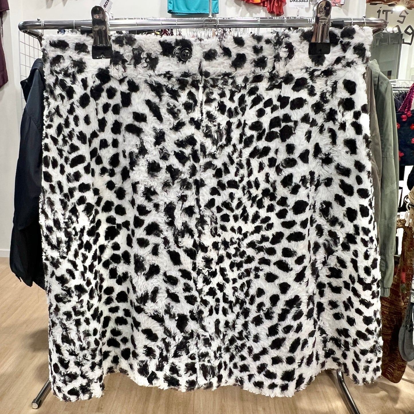 Leopard print fabric on a clothing rack in a store setting
