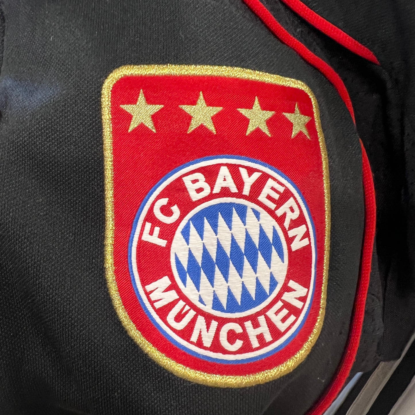 FC Bayern Munich logo on a sports jacket with red and gold accents