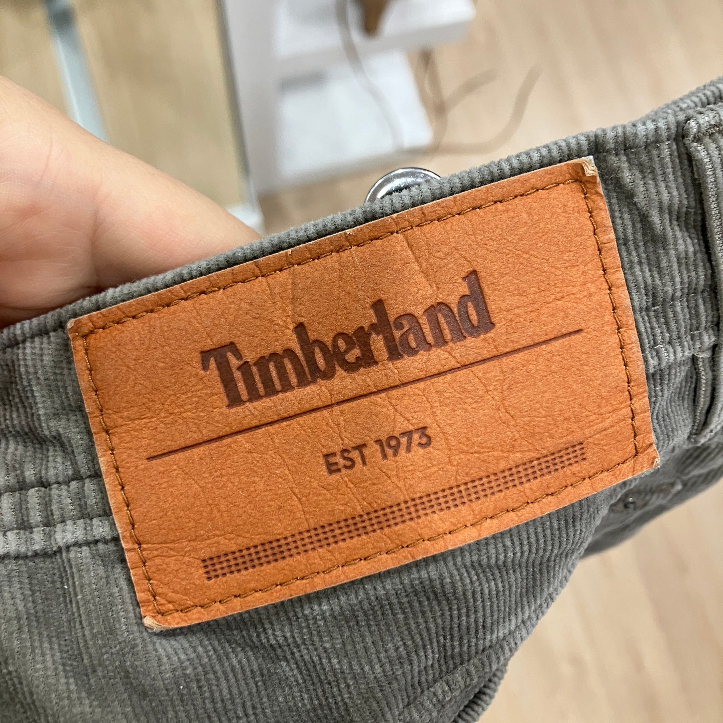 Timberland label on a green corduroy fabric