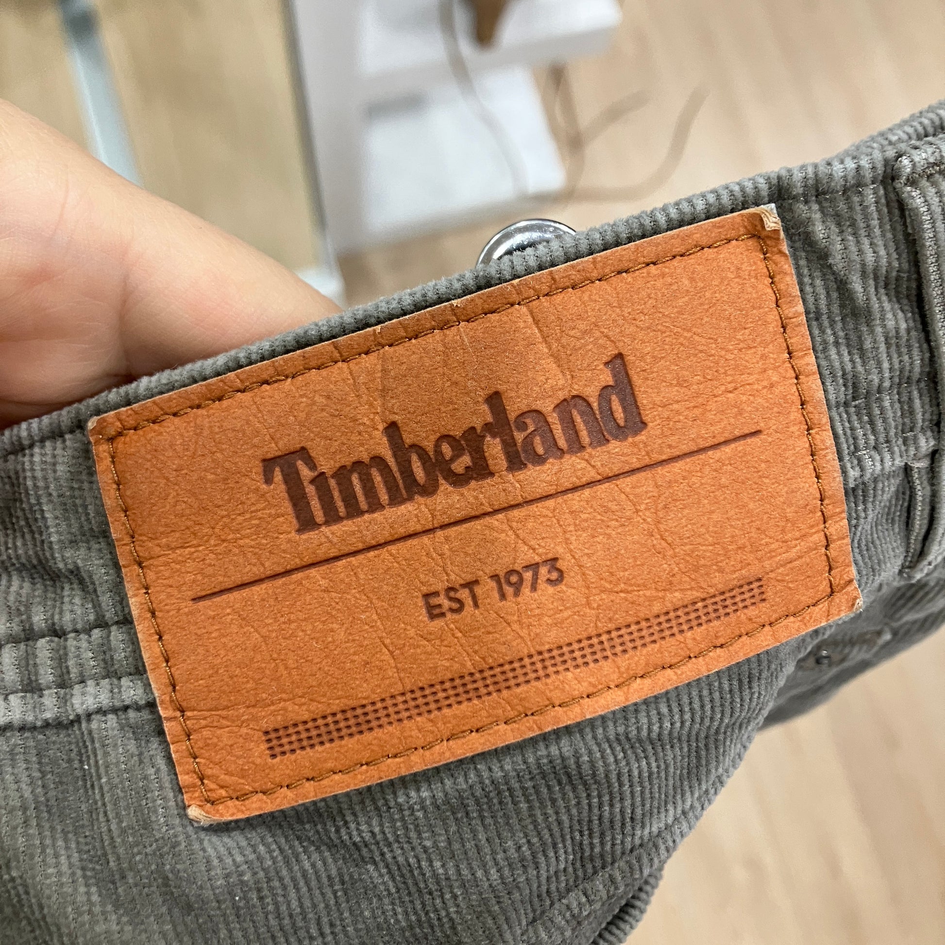 Timberland label on a green corduroy fabric