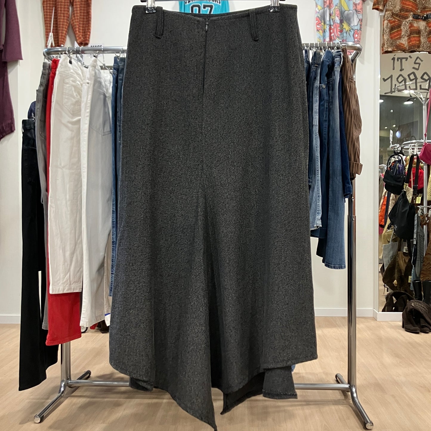Gray skirt hanging on a rack in a clothing store