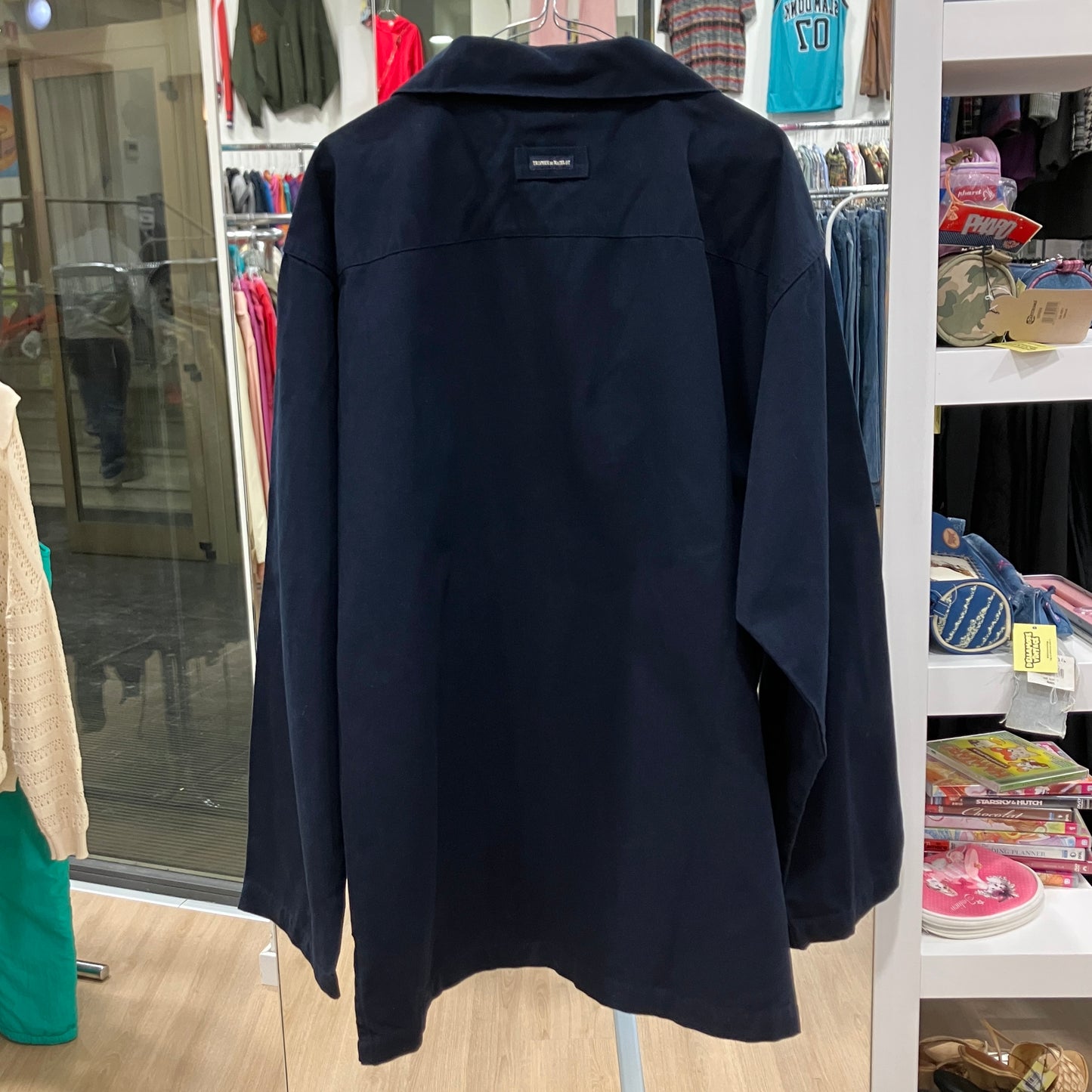 Navy blue shirt on a mannequin in a store setting
