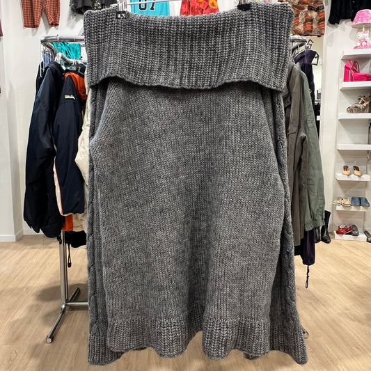 Gray knitted sweater on a hanger in a store setting