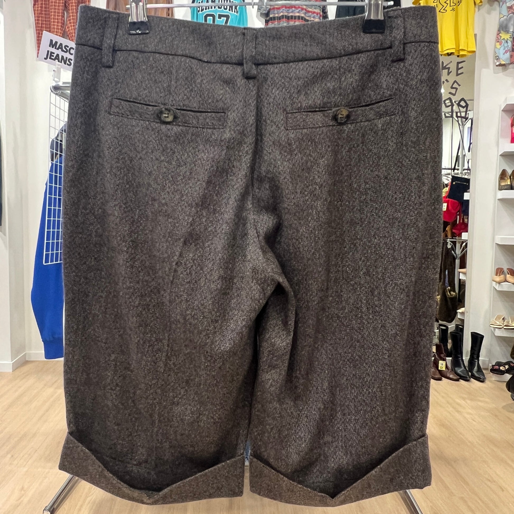 Gray shorts on a hanger in a store setting