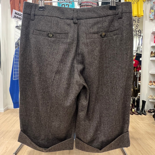 Gray shorts on a hanger in a store setting