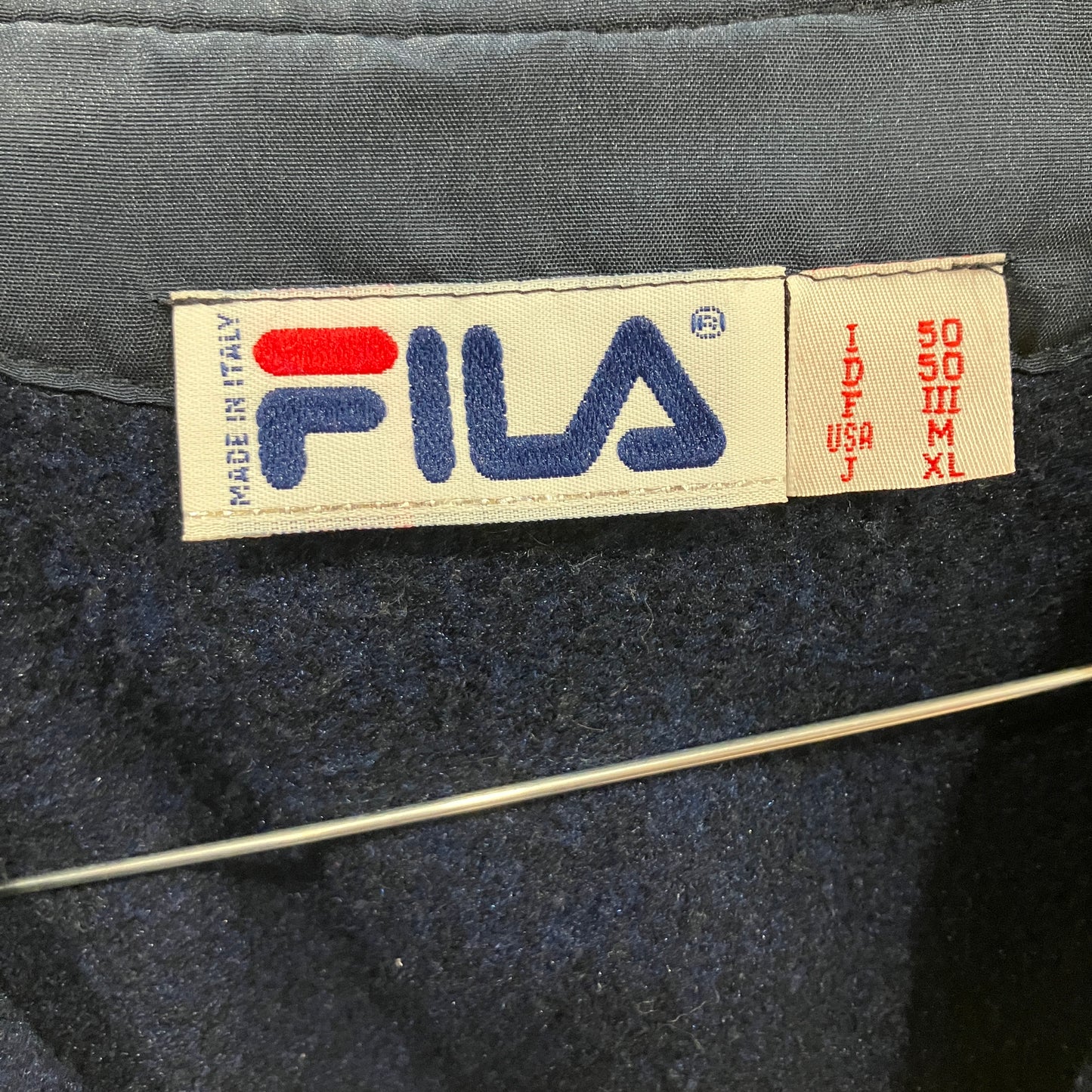 Fila label on a dark fabric background