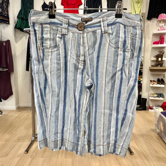 Striped denim shorts hanging on a rack in a store setting