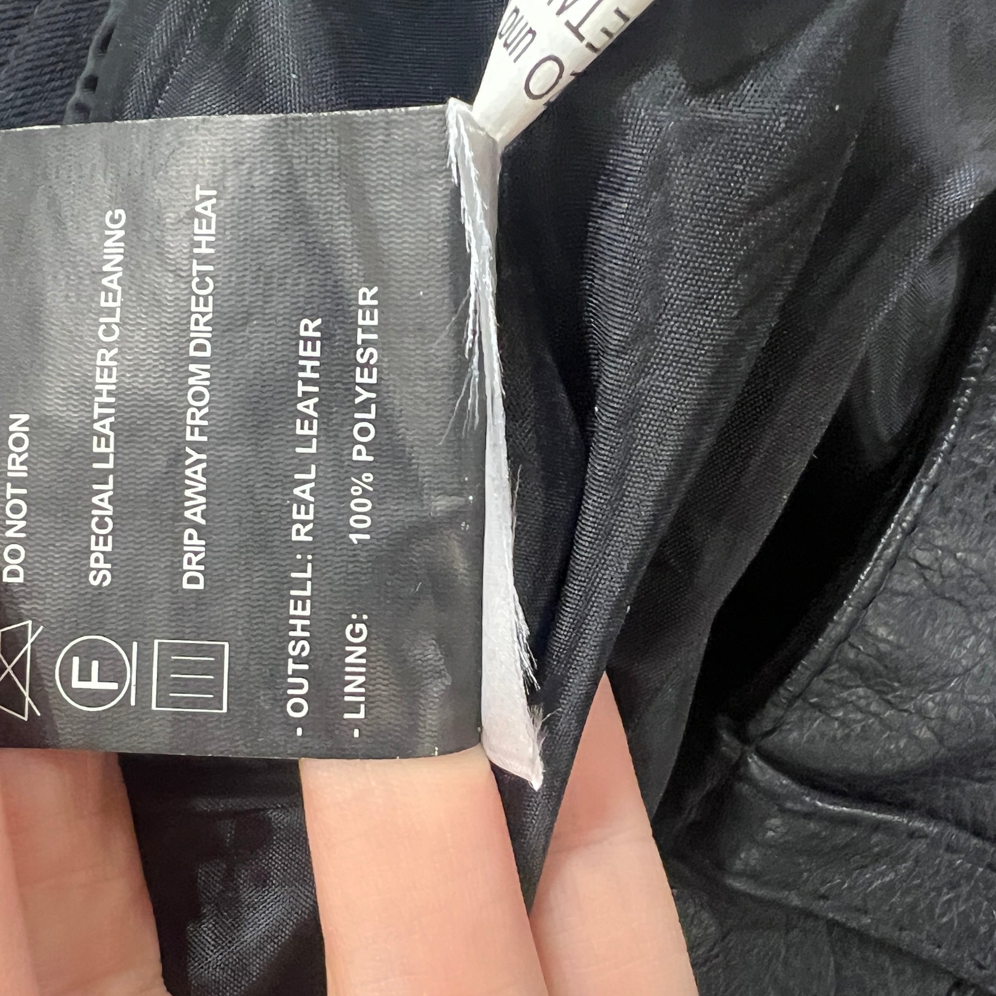 Close-up of a leather pants label with care instructions