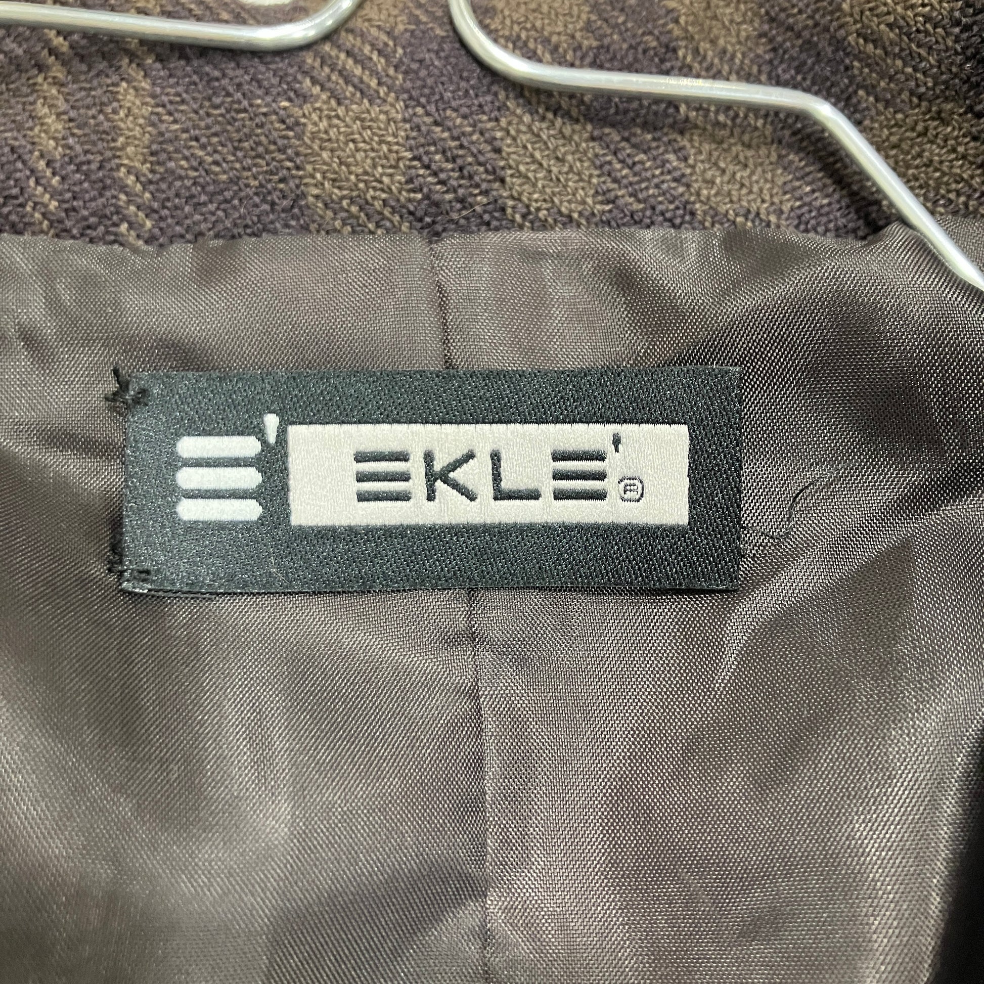 EKLE label on a textured fabric background