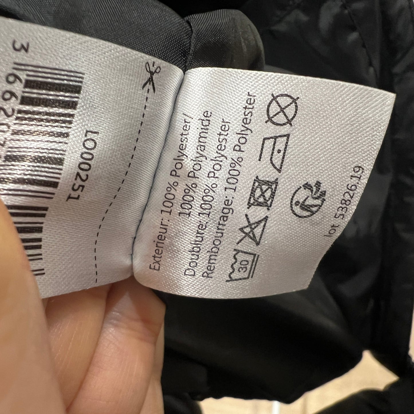 Close-up of clothing labels with text and symbols on a black background