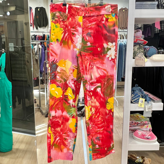 Floral pants hanging in a store with various items in the background