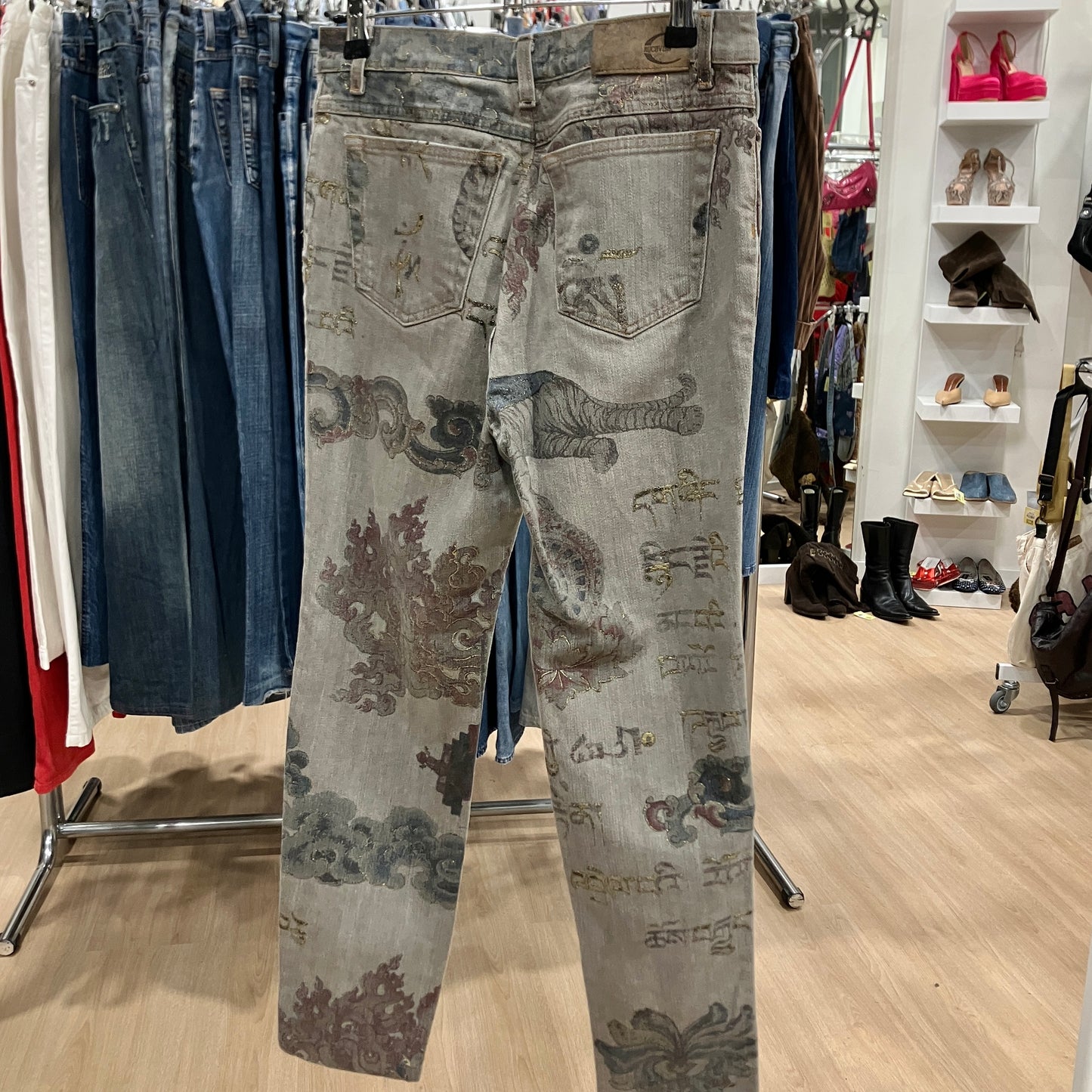 Light blue jeans with floral patterns hanging in a store