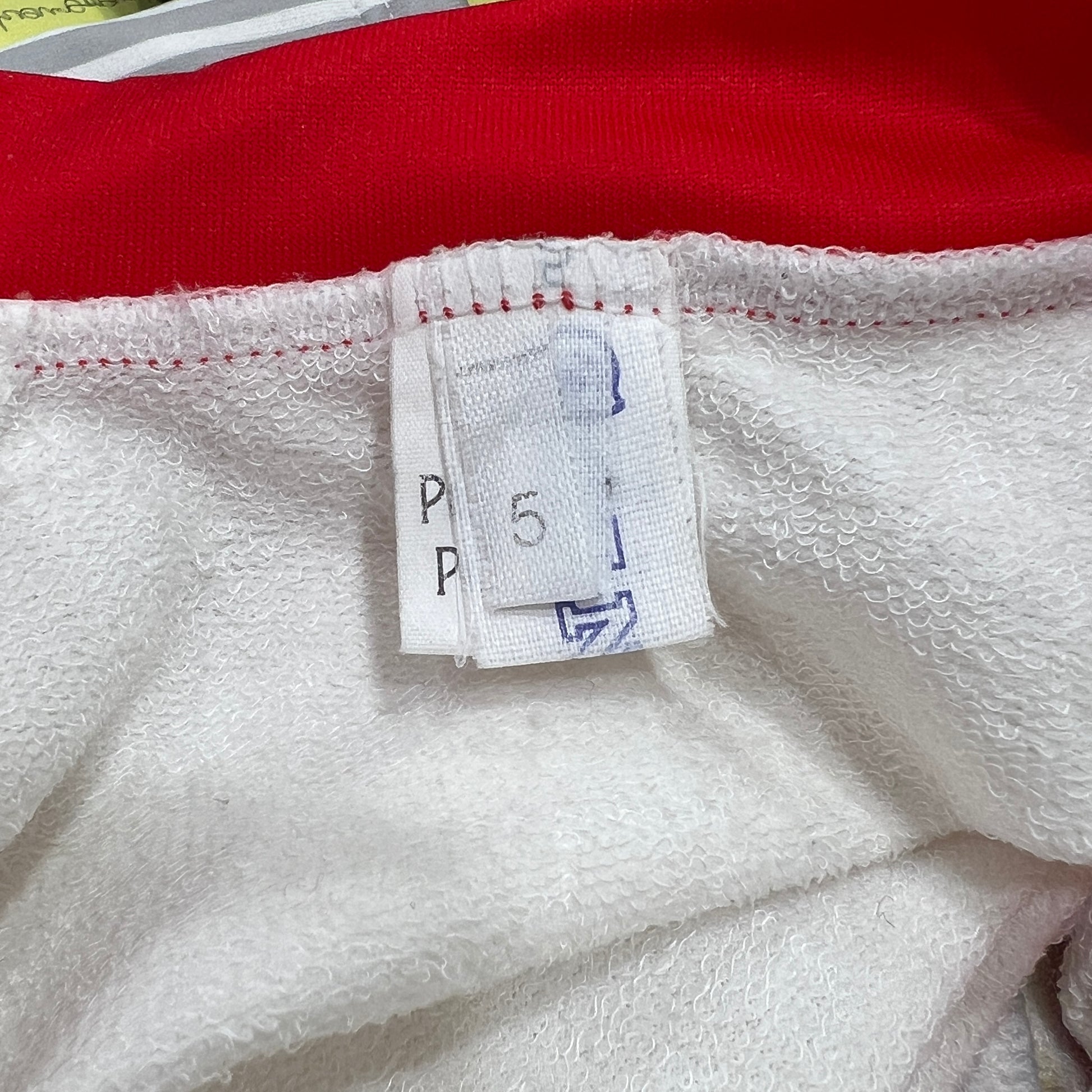 Close-up of a fabric tag on a red and white garment