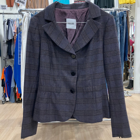 Plaid jacket with a tag on a rack in a store setting
