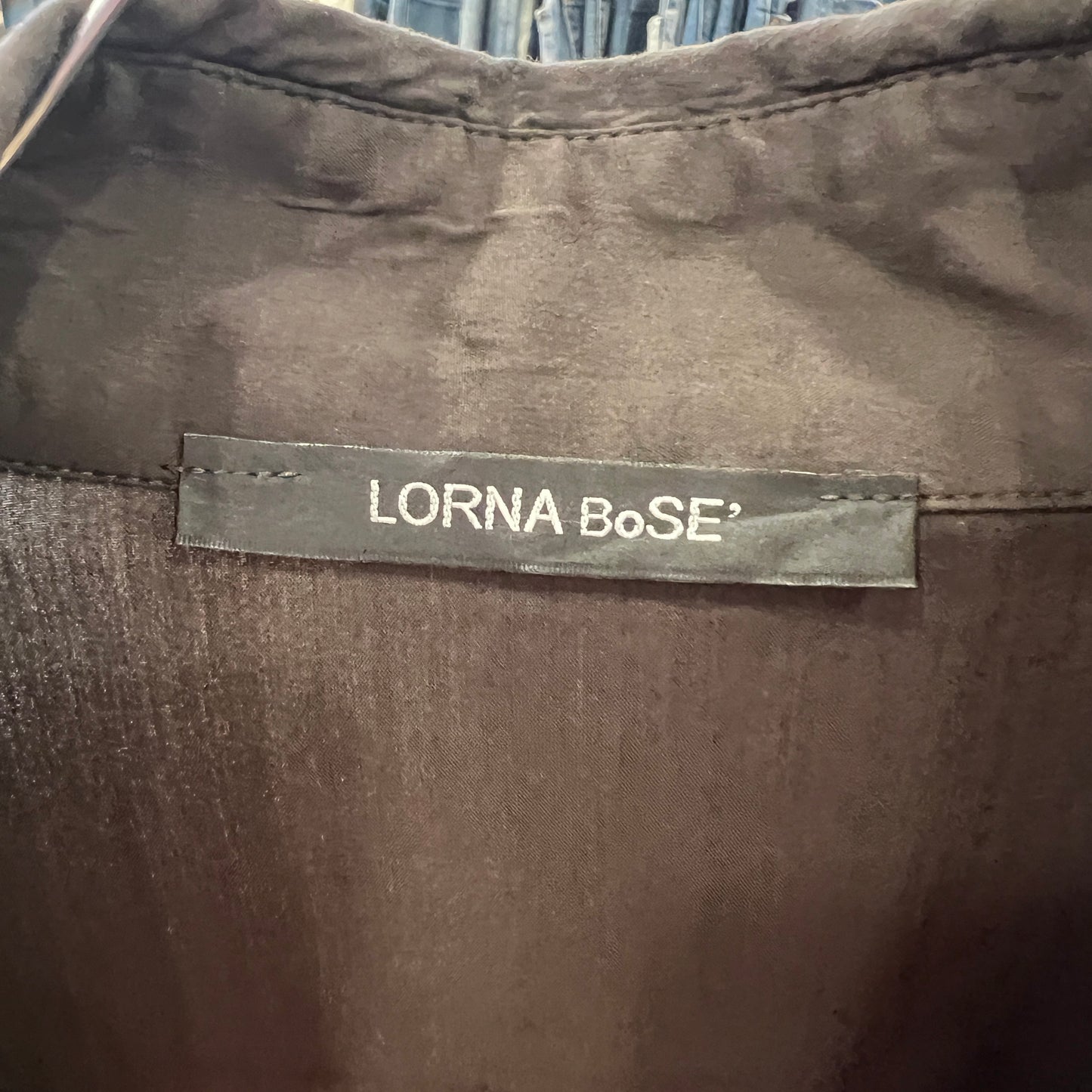Label with 'LORNA BoSE' on a brown fabric background
