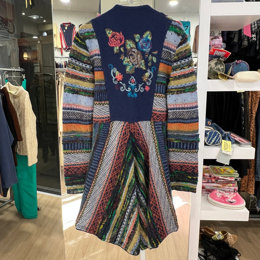 Colorful embroidered dress on a mannequin in a store setting
