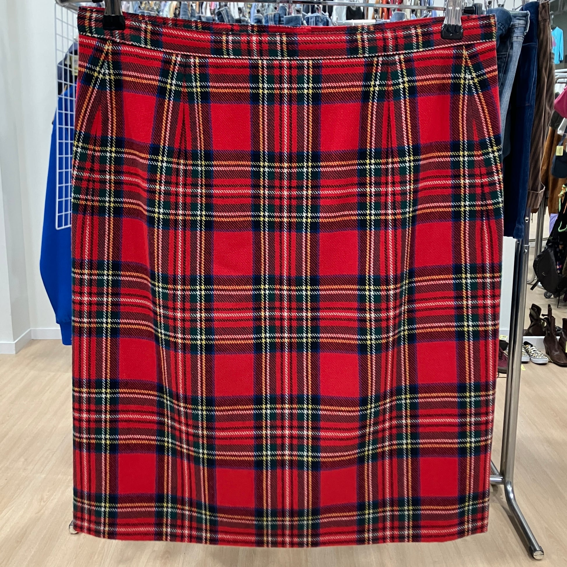 Red plaid skirt on a rack in a store setting