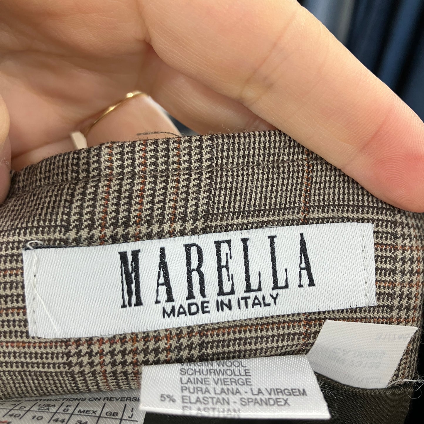 MARELLA label on a fabric with a hand holding it
