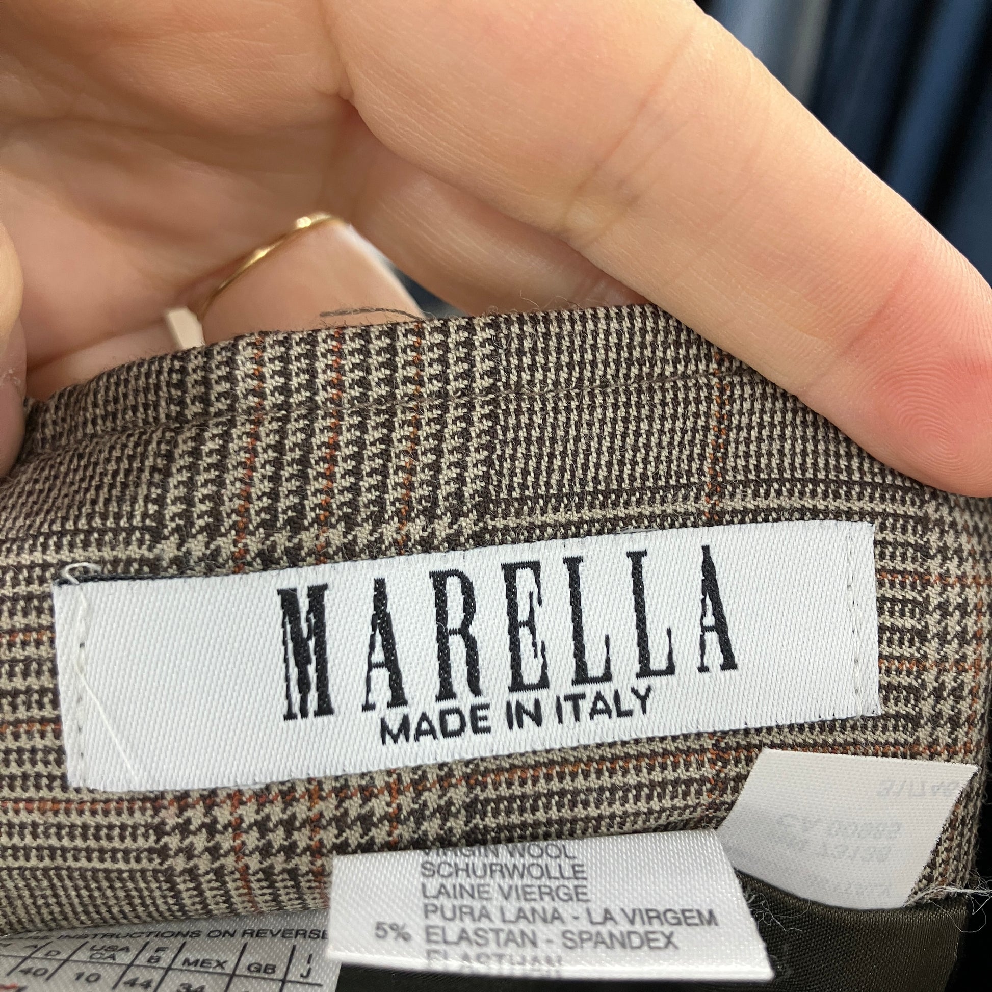 MARELLA label on a fabric with a hand holding it