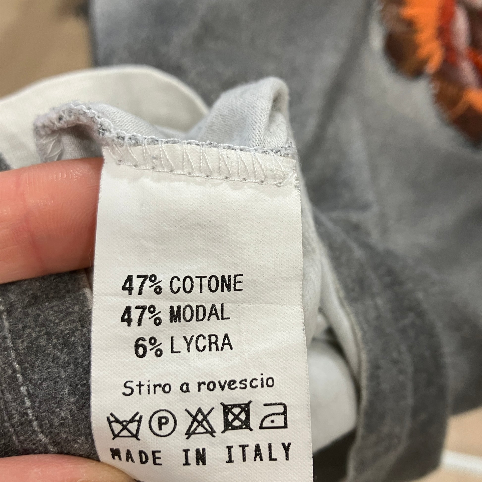 Fabric label with material composition and care instructions on a garment