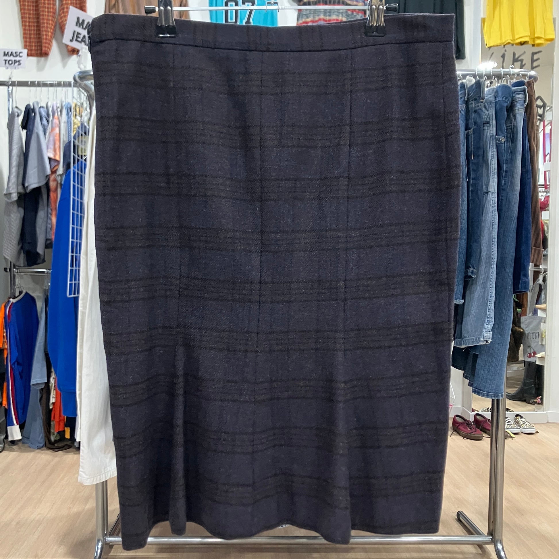 Brown plaid skirt on a clothing rack in a store setting