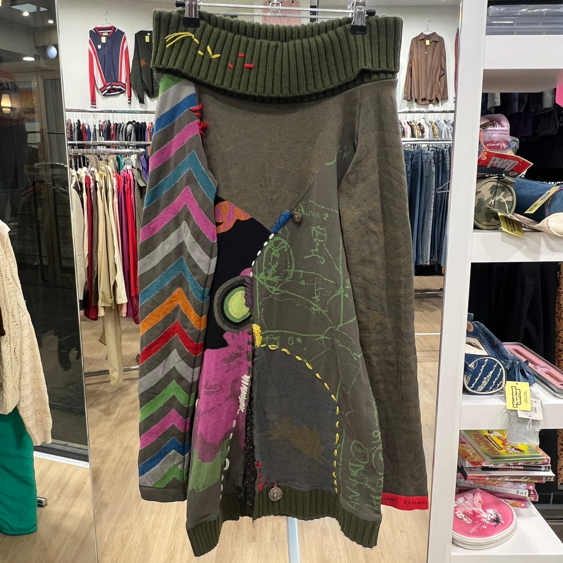 Hanging sweater with colorful patterns in a store setting