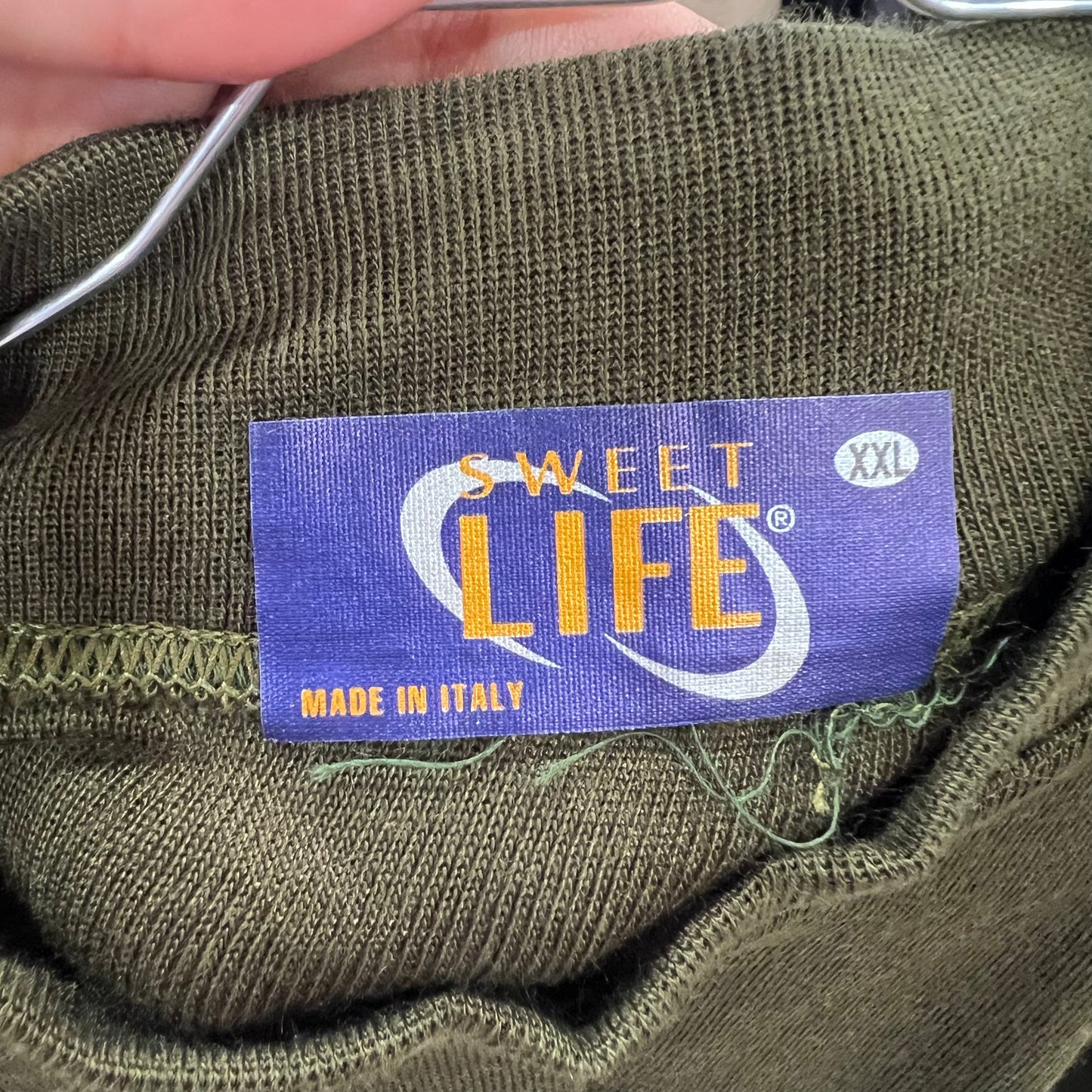 Green fabric with a 'Sweet Life' label indicating XXL size, made in Italy